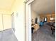View of the living room from the screened-in lanai with an entertainment center and carpet flooring at 3559 Lake Bayshore Dr # J-204, Bradenton, FL 34205