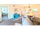 Inviting living space highlighted by the blue cabinet, comfortable seating, and a view into the dining area at 3559 Lake Bayshore Dr # J-204, Bradenton, FL 34205