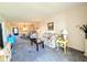 Comfortable living room with a floral sofa, accent tables, and view into the dining room with chandelier at 3559 Lake Bayshore Dr # J-204, Bradenton, FL 34205