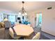 Charming living space featuring an octagon table with chairs and a light fixture with a chandelier at 3559 Lake Bayshore Dr # J-204, Bradenton, FL 34205