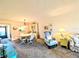 Open-concept living and dining area featuring neutral tones, carpet floors, and natural light at 3559 Lake Bayshore Dr # J-204, Bradenton, FL 34205