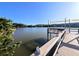 Picturesque waterfront view from the dock with a seating area, surrounded by lush landscaping at 3559 Lake Bayshore Dr # J-204, Bradenton, FL 34205