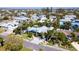 A high angle aerial view of a single Gathering home, manicured landscaping, and surrounding tropical neighborhood at 403 75Th St, Holmes Beach, FL 34217