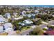 A serene neighborhood is captured from above, with homes nestled among lush greenery, near the Gulf at 403 75Th St, Holmes Beach, FL 34217