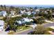An aerial view of the lovely blue home surrounded by lush green tropical landscaping at 403 75Th St, Holmes Beach, FL 34217