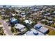 Aerial shot shows the tropical landscape surrounding beautiful homes near the Gulf of Mexico at 403 75Th St, Holmes Beach, FL 34217