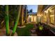 Landscaped backyard featuring a green lawn, mature trees, and a charming blue home at 403 75Th St, Holmes Beach, FL 34217
