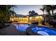 Beautifully landscaped backyard with a pool, spa, and outdoor seating areas at 403 75Th St, Holmes Beach, FL 34217