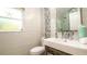 Stylish bathroom featuring a modern sink, sleek fixtures, and a window providing natural light at 403 75Th St, Holmes Beach, FL 34217