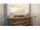 Bedroom detail showcasing a stylish dresser and a bright window, enhancing the room's charm and functionality at 403 75Th St, Holmes Beach, FL 34217