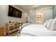 Bedroom boasts a colorful dresser, beachy decor, and a glimpse into the en suite bathroom at 403 75Th St, Holmes Beach, FL 34217