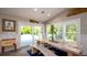Dining area with rustic wood table, bench seating, a cooler, and a view of the pool and backyard at 403 75Th St, Holmes Beach, FL 34217
