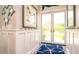 Welcoming entryway featuring charming starfish decor, white wainscoting and a blue starfish patterned rug at 403 75Th St, Holmes Beach, FL 34217