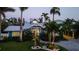 Quaint single-story home featuring lush landscaping and green lawn that highlight the driveway and entryway at 403 75Th St, Holmes Beach, FL 34217