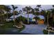 Stunning, light-blue coastal home with lush landscaping, a paver driveway and a metal roof in a desirable neighborhood at 403 75Th St, Holmes Beach, FL 34217
