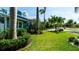 Landscaped front yard with mature trees and lush green lawn at 403 75Th St, Holmes Beach, FL 34217