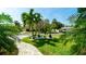 Lush front yard with tropical plants and paver walkway leading to the house at 403 75Th St, Holmes Beach, FL 34217