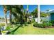 Professionally landscaped front yard with manicured lawn and tropical plants at 403 75Th St, Holmes Beach, FL 34217