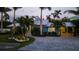 Twilight accentuates the home's lush landscaping and driveway, enhancing the home's curb appeal at 403 75Th St, Holmes Beach, FL 34217