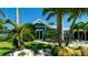 Charming blue home boasts lush landscaping and a well-manicured lawn, creating a welcoming curb appeal at 403 75Th St, Holmes Beach, FL 34217
