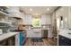 Beautiful kitchen with white cabinets, stainless steel appliances, a farm sink, and a blue range at 403 75Th St, Holmes Beach, FL 34217
