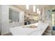 Bright, stylish kitchen with white cabinetry, a long quartz countertop island, and coastal-themed decor at 403 75Th St, Holmes Beach, FL 34217
