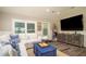 Inviting living room with a comfortable white sectional, blue accents, and a large flat-screen TV at 403 75Th St, Holmes Beach, FL 34217