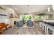 Open-concept living room featuring coastal decor, wood floors, stylish seating, and a beachy fireplace at 403 75Th St, Holmes Beach, FL 34217