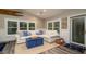 Bright living room with large windows, white sectional sofa, and coastal-themed decor at 403 75Th St, Holmes Beach, FL 34217