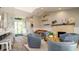 Spacious living area showcasing a fireplace, comfortable seating, and a seamless transition to the entryway and kitchen at 403 75Th St, Holmes Beach, FL 34217