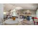Open living space with a kitchen island, dining area, and living room with a decorative fireplace at 403 75Th St, Holmes Beach, FL 34217