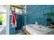 Stylish outdoor shower featuring blue tiling, surfboard decor, and a convenient sink at 403 75Th St, Holmes Beach, FL 34217