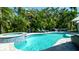 An inviting pool with a spa is surrounded by lush tropical landscaping at 403 75Th St, Holmes Beach, FL 34217