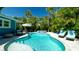 A tranquil backyard with a refreshing pool, spa, and outdoor seating area at 403 75Th St, Holmes Beach, FL 34217