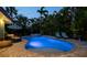 Inviting backyard pool with spa, lush landscaping, and lounge seating at 403 75Th St, Holmes Beach, FL 34217