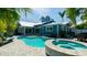 The backyard pool features a connected spa and is surrounded by a stone patio at 403 75Th St, Holmes Beach, FL 34217