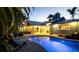 Backyard with a private pool and spa surrounded by lush tropical foliage at 403 75Th St, Holmes Beach, FL 34217