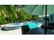 Inviting backyard featuring a pool, spa, and shaded outdoor dining area at 403 75Th St, Holmes Beach, FL 34217