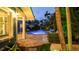 Inviting backyard oasis with a freeform pool, spa, and ample seating for outdoor relaxation and entertainment at 403 75Th St, Holmes Beach, FL 34217