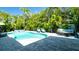 Beautiful backyard features a sparkling pool, spa, and relaxing lounge area at 403 75Th St, Holmes Beach, FL 34217