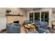 Cozy sitting area features a stone fireplace, comfortable chairs, and poolside views at 403 75Th St, Holmes Beach, FL 34217