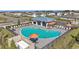 Aerial view of community pool with lounge chairs, umbrellas, cabana and surrounding new construction neighborhood at 4304 112Th E St, Palmetto, FL 34221