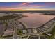 Aerial view of a lakeside community featuring beautiful homes and stunning sunset at 508 Blue Shell Loop, Sarasota, FL 34240