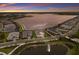 Panoramic aerial view of the neighborhood and beautiful lake at sunset at 508 Blue Shell Loop, Sarasota, FL 34240