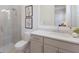 Modern bathroom with a glass-enclosed shower, white vanity, and neutral tile at 508 Blue Shell Loop, Sarasota, FL 34240