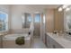 Bright bathroom featuring soaking tub, tiled shower, dual sinks, and storage at 508 Blue Shell Loop, Sarasota, FL 34240