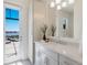 Bright bathroom featuring double vanity, modern fixtures, and views of the waterfront from the patio at 508 Blue Shell Loop, Sarasota, FL 34240