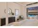 Bright bedroom featuring elegant furniture, stylish decor, and views of the outdoor pool at 508 Blue Shell Loop, Sarasota, FL 34240