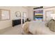 Bedroom featuring a modern dresser, comfy chair, and outdoor access leading to a stunning pool and lake view at 508 Blue Shell Loop, Sarasota, FL 34240