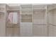 Spacious walk-in closet with built-in shelving, drawers, and ample hanging space for storage and organization at 508 Blue Shell Loop, Sarasota, FL 34240